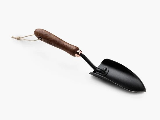 A tool with a black metal trowel and wooden handle.