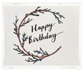 A card reading "happy birthday" has a cream colored background. There is a illustration of a brown juniper branch with green leaves and blue berries. 