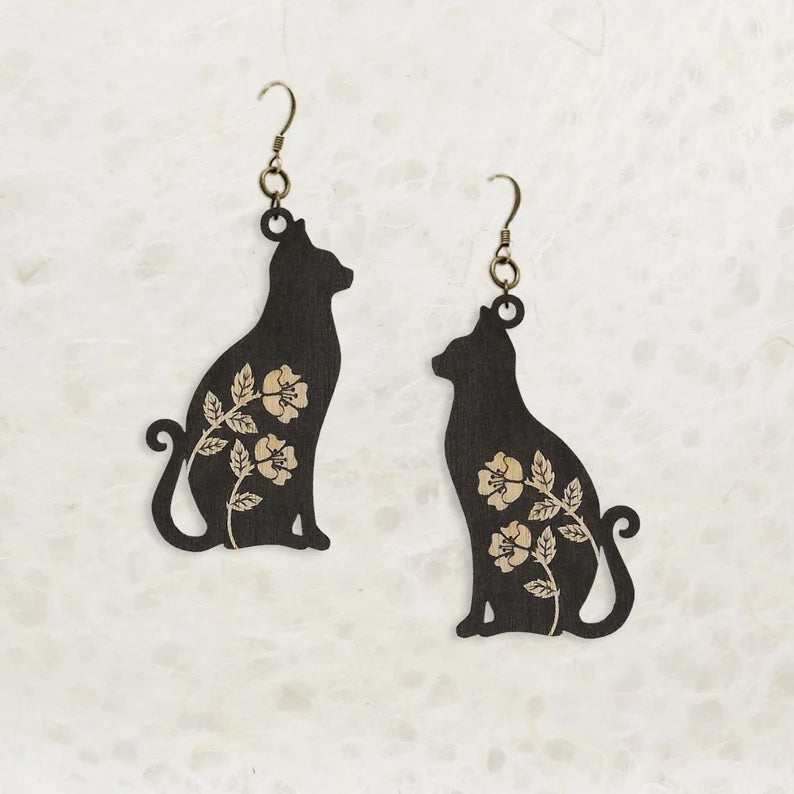 Black cat earrings. The cats have white flowers etched into them.