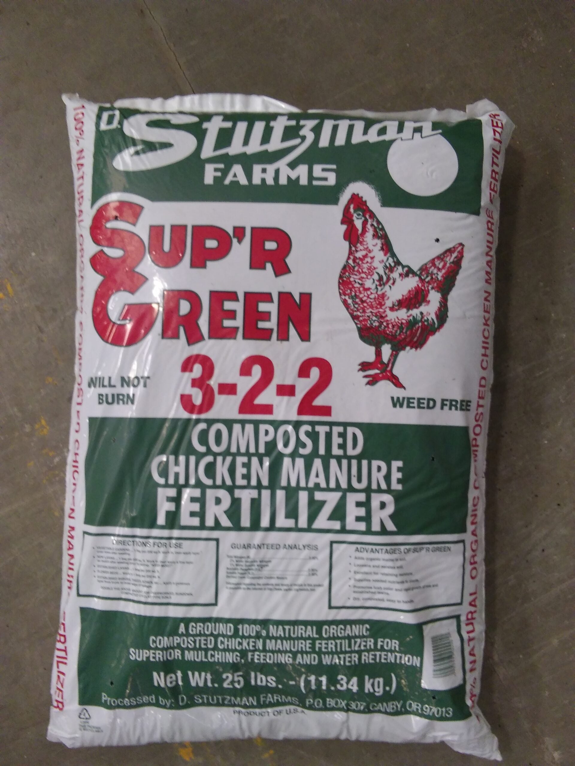 A white and green bag with a red drawing of a chicken.