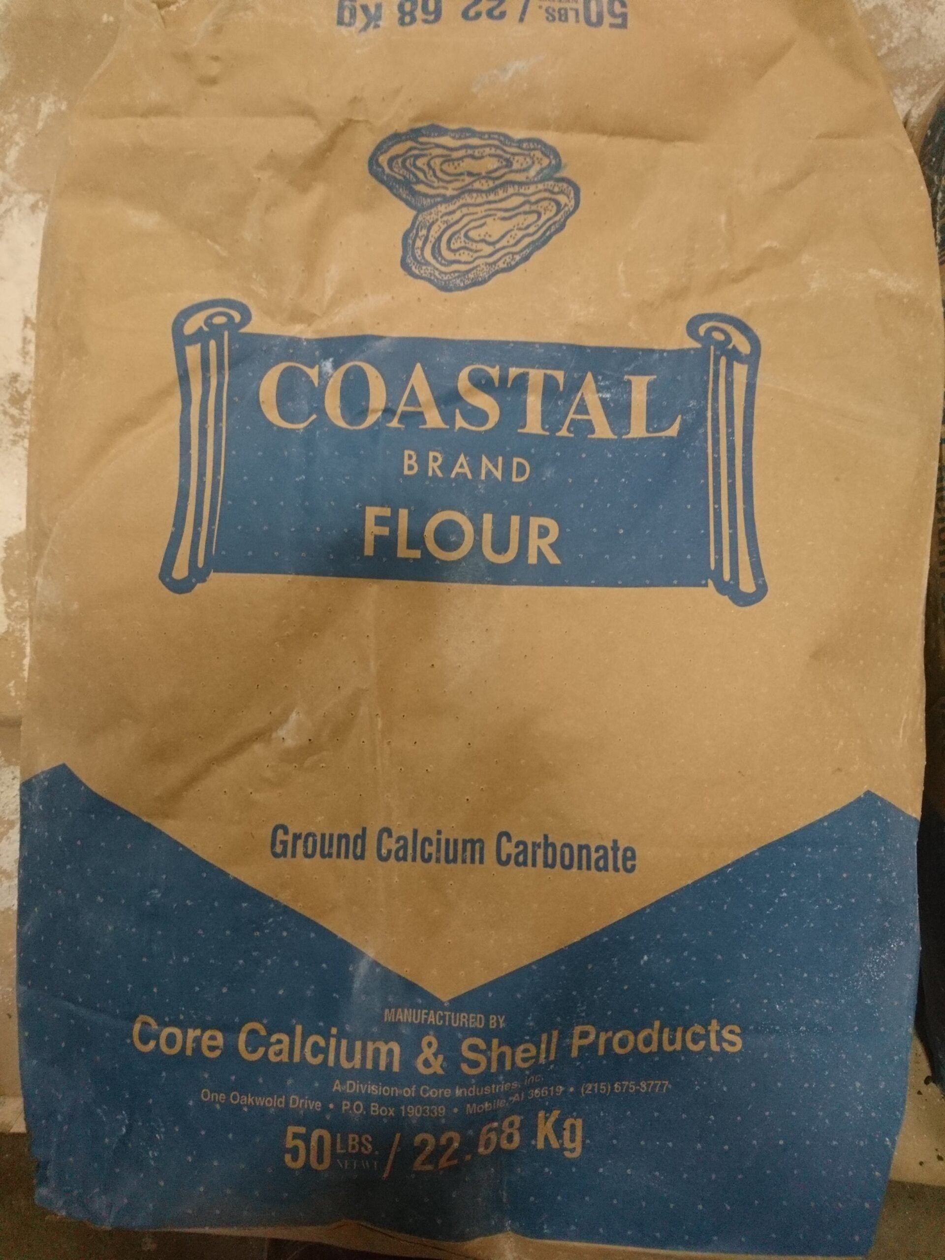 A large brown bag with blue labels and a drawing of an open oyster shell.