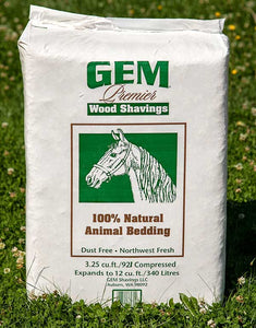 A white bag filled with wood shavings. It has an illustration of a horse on the front.