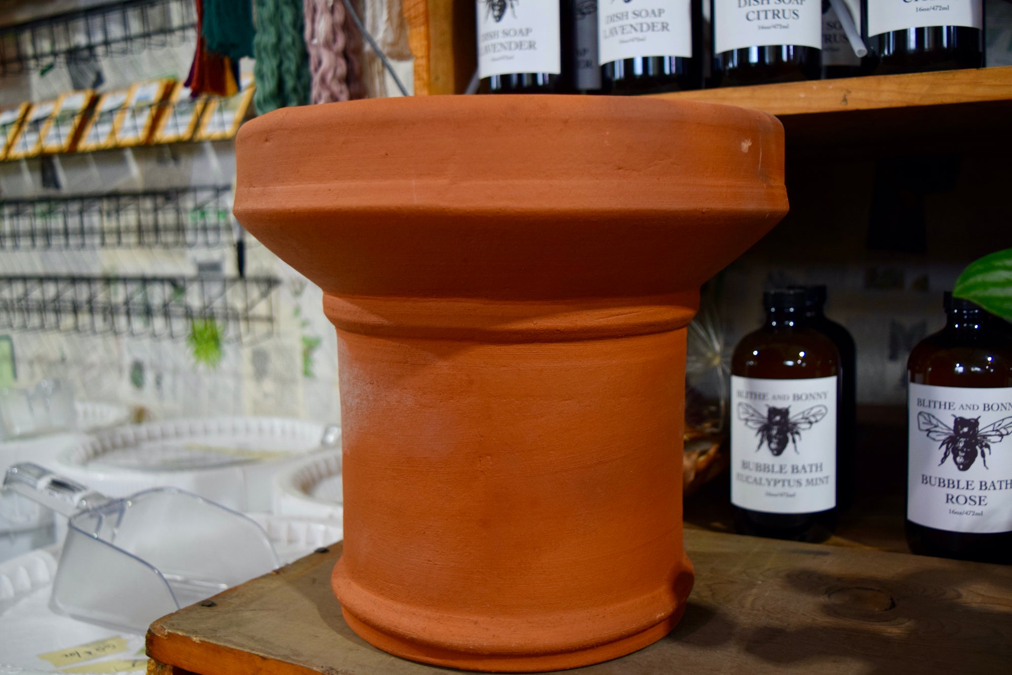A pedestal planter made of terracotta. 
