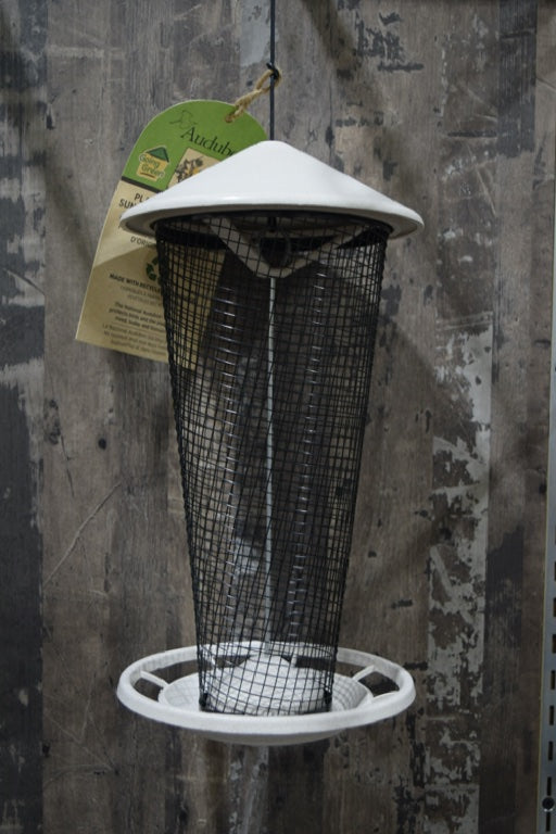 A large black mesh feeder with an off-white top and bottom.