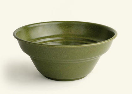 A green planter that looks like a bowl.