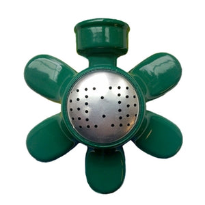 A green metal sprinkler with a silver center. It is shaped like a daisy.