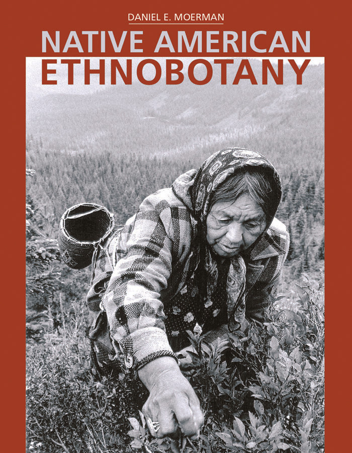 A red cover with a black and white photo of an elderly Indigenous person grabbing a handful of a plant