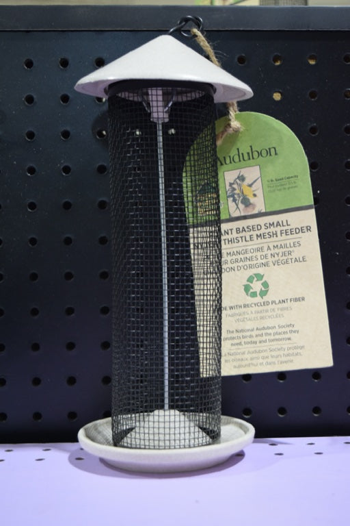 A black mesh feeder with an off-white top and bottom. 