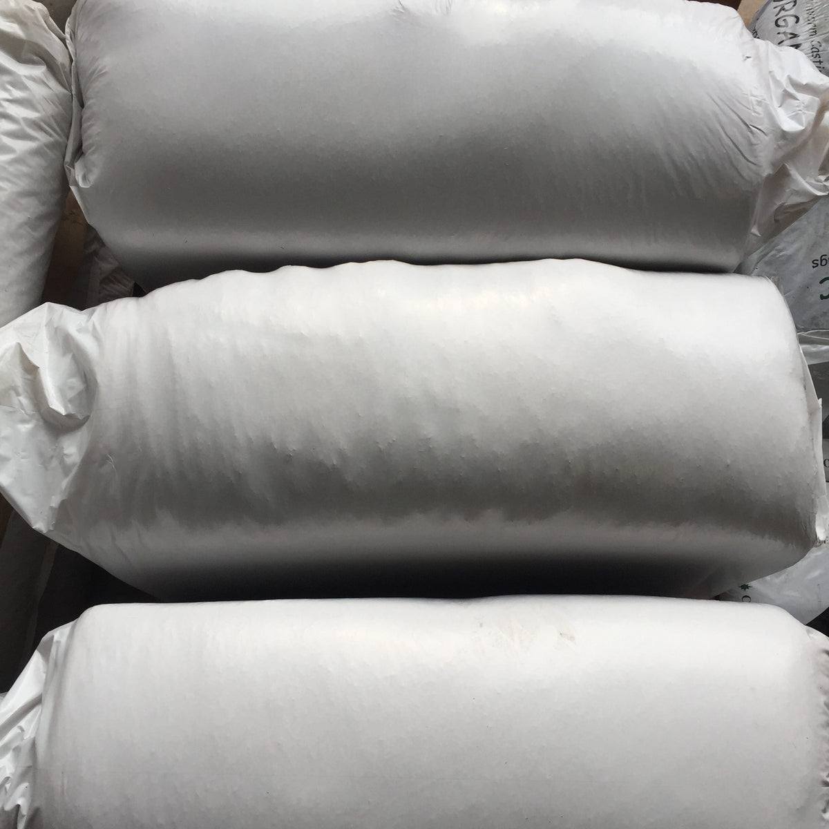 Large white bags stacked on top of each other.