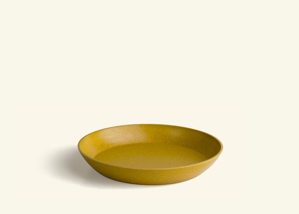 A burnt yellow colored saucer