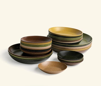 Multiple colors of saucers stacked on top of each other.