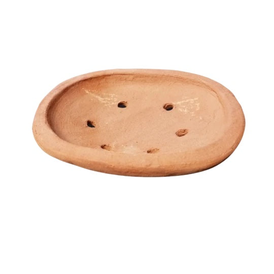 A round terracotta tray with 6 holes around the center.