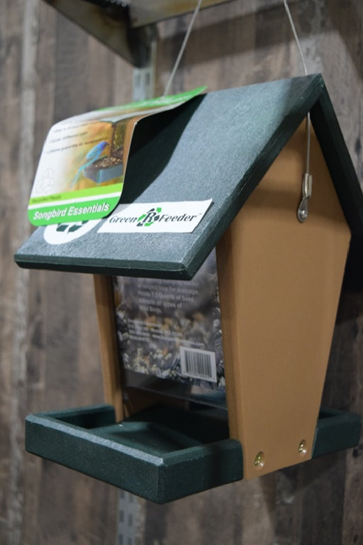 A green and brown feeder with a clear center.