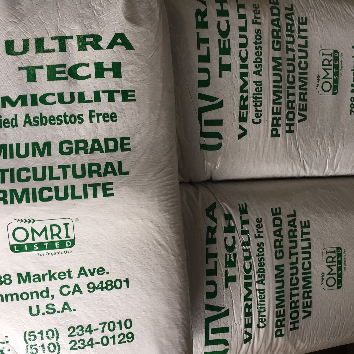 Large white bags of vermiculite stacked on top of each other.