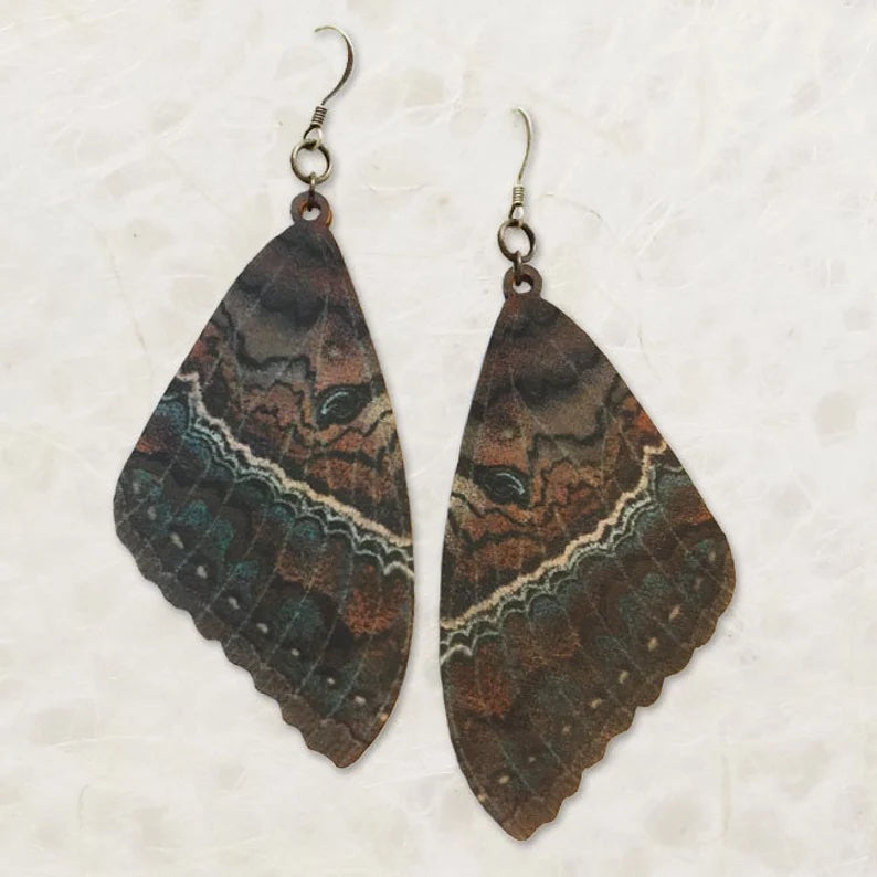 Dark colored earrings resembling Witch Month wings.
