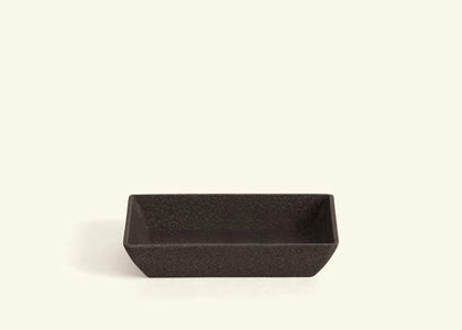 A rectangular black saucer.